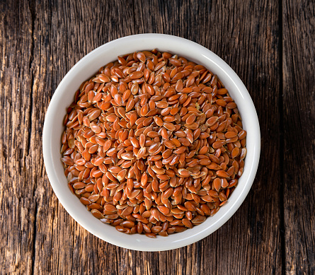 Flax seeds in bowl on table