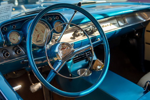 Interior of blue Chevrolet Bel Air, retro torpedo car, vintage steering wheel, speedometer. Snohomish, WA, USA - September 2022