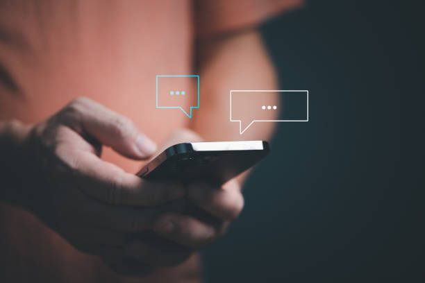 istock Man hands using smartphone texting Live chat chatting and social network concepts, chatting conversation working at home in chat box icons pop up. Social media marketing technology concept. 1436889547