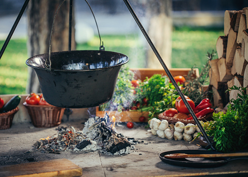 Traditional goulash soup in cauldron , meal cooking outdoors