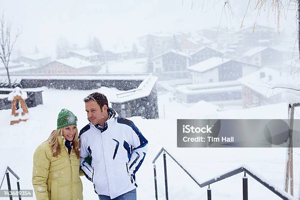 Couple Walking Together In Snow Stock Photo - Download Image Now - 30-39 Years, 35-39 Years, 40-44 Years