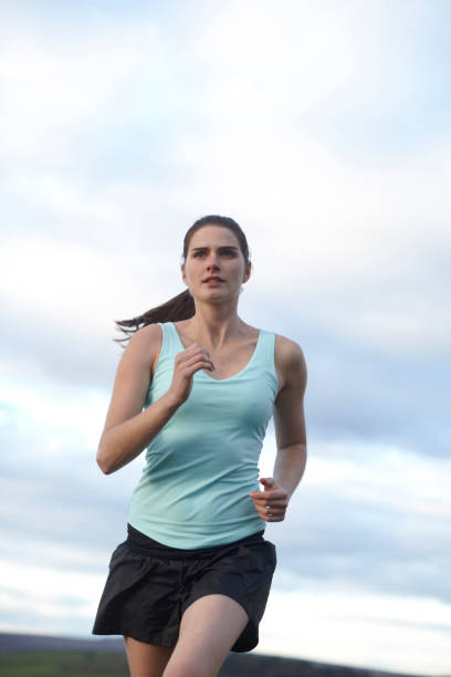 istock Woman running outdoors 143689411