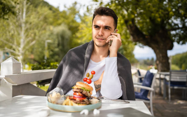 istock one man using mobile phone while sit on the terrace of the restaurant 1436895162