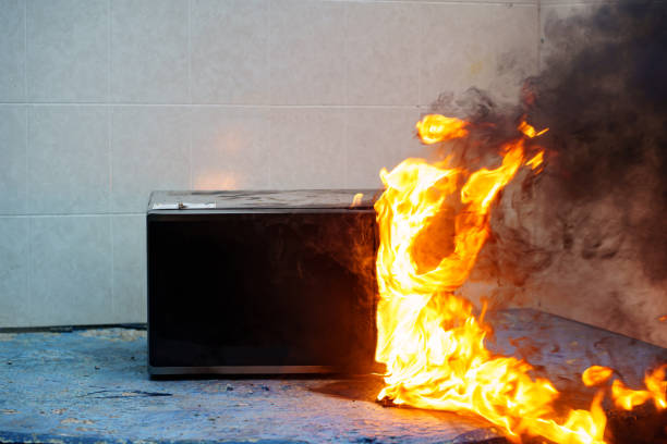 istock microwave oven on fire. the concept of fire in the kitchen. 1436895862