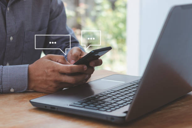 istock Social media marketing technology concept. Businessman hand using smartphone typing Live chat chatting and social network concepts, chatting conversation working at home in chat box icons pop up. 1436897538