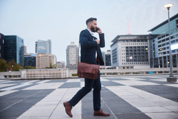 istock Businessman talking on his phone while leaving work for the day 1436898517