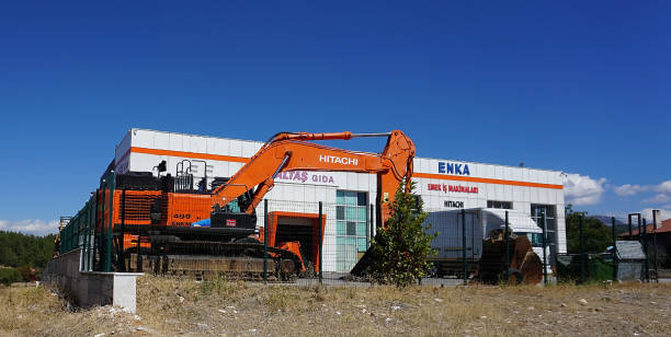 excavator positioned near building