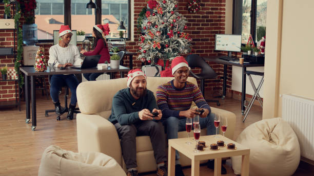 istock Happy people playing video games on console during christmas time 1436900089
