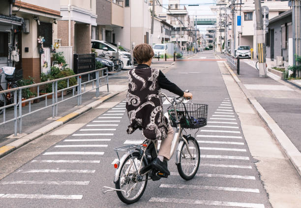istock Senior woman with bicycle 1436902143