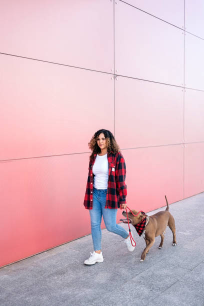 istock African Woman Walking her Dog 1436904628