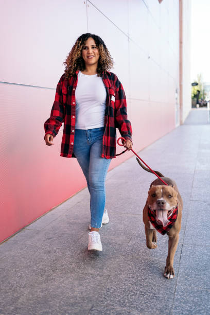 istock African Woman Walking her Dog 1436904631