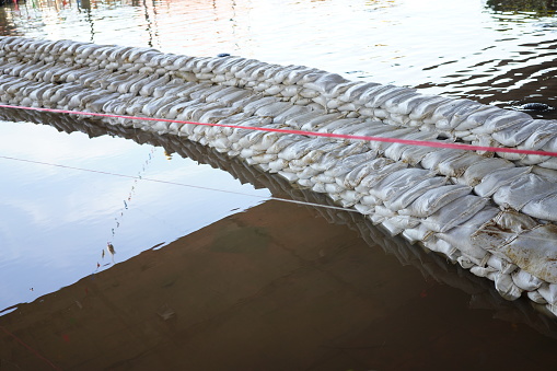 Sandbags against floods on a river bank