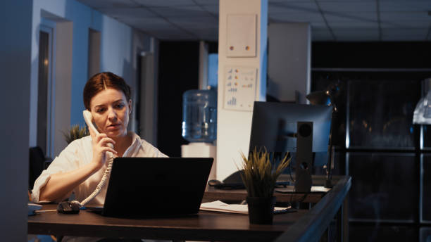 istock Empowered female manager talking on landline phone call 1436905879