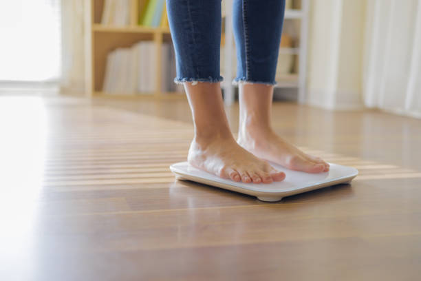 istock closeup of weighing on scale 1436906124