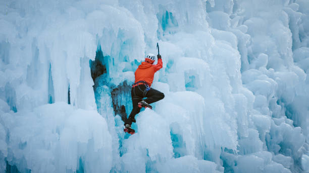 istock Alpinist man on a frozen waterfall 1436907239