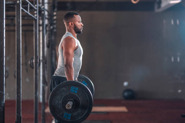 istock Black Male Muscular Athlete Practicing Deadlift with Barbell 1436909105