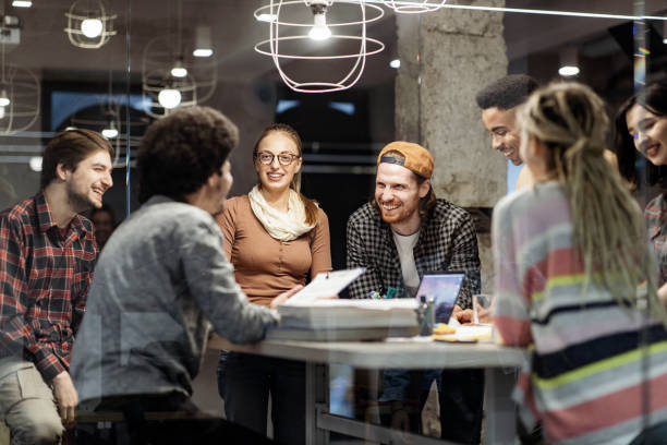 istock Happy freelancers talking on a meeting at casual office. 1436909113
