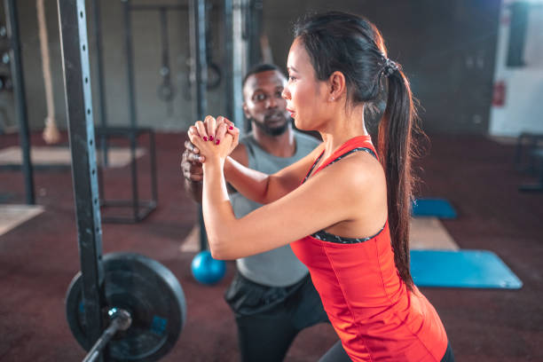 istock Male instructor teaching sportswoman at gym 1436909115