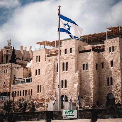Jerusalem, Israel – October 07, 2022: The Israeli flag at the Western Wall in Jerusalem, Israel.