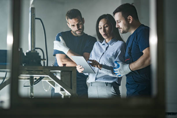 istock Manual workers using touchpad with Asian female inspector in a factory. 1436911537