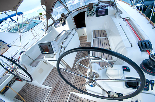 Winch with rope and handle on sailboat during sailing.