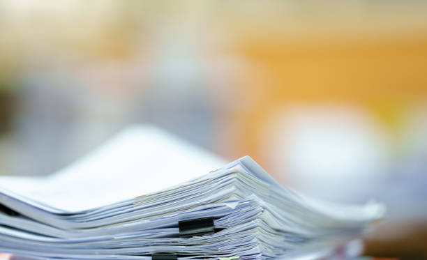 istock extreamly close up the stacking of office working document with paper clip folder at office 1436911713