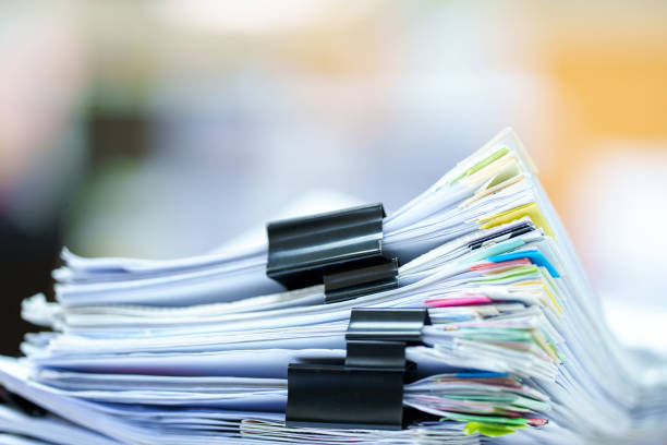 istock extreamly close up the stacking of office working document with paper clip folder at office 1436911745