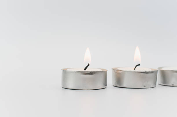 istock burning pure wax scented tea lights on a white background with space for text 1436911758