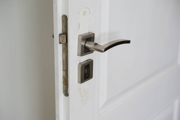 istock Closeup shot of a silver handle on a white door 1436911799
