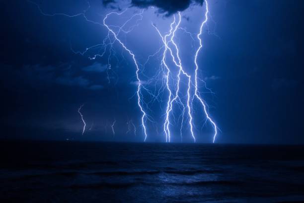 istock Flash of lightning over the sea thunderstorm clouds 1436911842