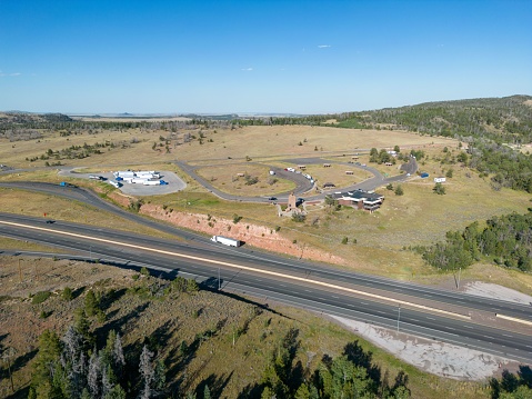 An aerial drone view of Lincoln Memorial rest stop on Interstate 80 near Laramie Wyoming under blue sky