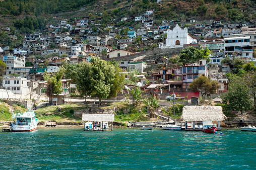 The village of San Antonio Palopo with its distinct white church, sits on the shore of lake Atitlan in Solola, Guatemala.