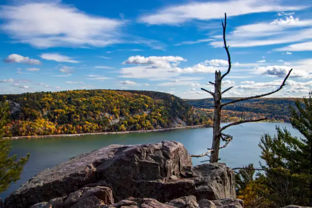 A beautiful view of Devil's Lake surrounded by dense trees and hills in state park Baraboo, Wisconsin