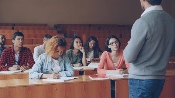 istock Emotional tutor is speaking to adult students explaining new information while attentive pupils are listening and taking notes. Profession, education and people concept. 1436913333