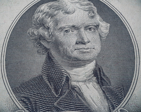 A closeup shot of the portrait of Thomas Jefferson on the US 2 Dollar Bill