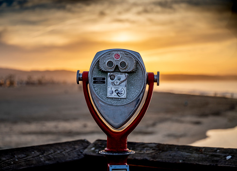 The Coin-operated binoculars on blurred background. Newport Beach, California