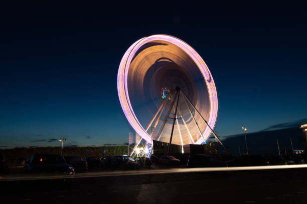 roda gigante com longa exposição em um parque de diversões à noite - ferris wheel wheel blurred motion amusement park - fotografias e filmes do acervo