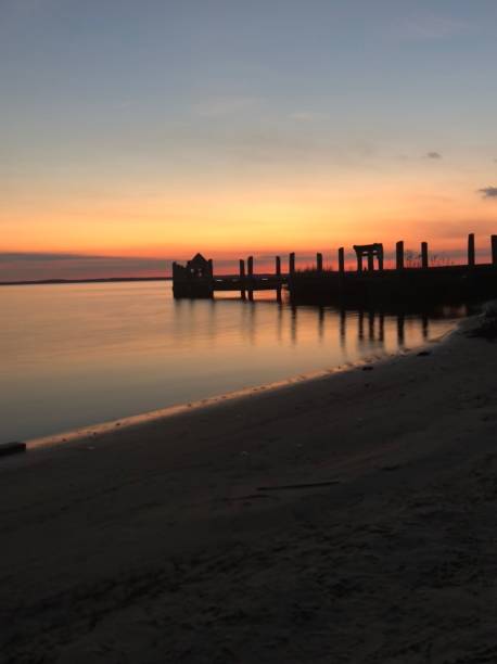 istock Wooden bridge on the beach at sunset, vertical 1436916518
