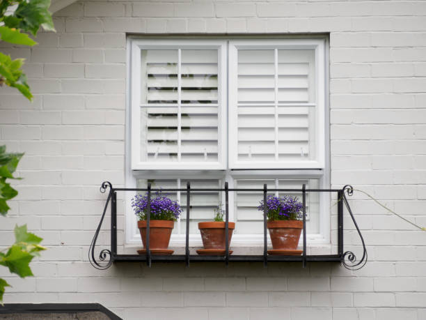 istock small balcony garden and white window on white brick wall 1436917054