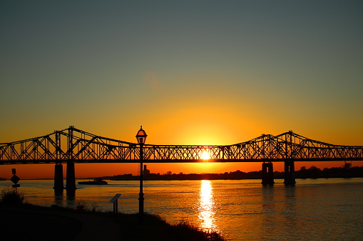 A scenic view of the Natchez–Vidalia Bridge in Louisiana on a sunset sky background