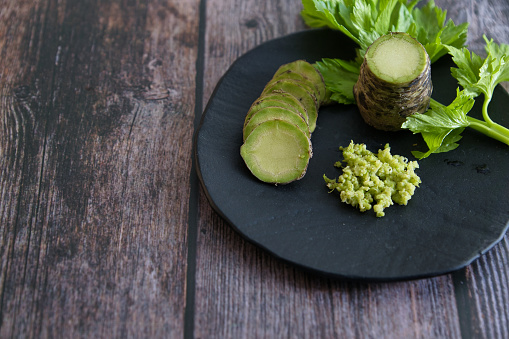 A plate of Japanese horseradish or wasabi on a wooden table