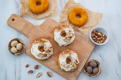 The carrot cake donuts with nuts and eggs for Easter