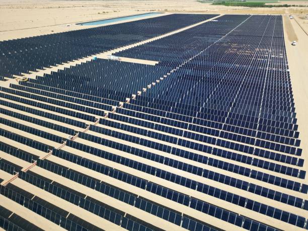 istock Array of polycrystalline silicon solar cells in solar power plant turned up skyward 1436922592