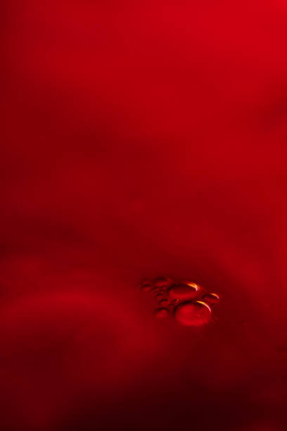 istock Vertical shot of liquid drops under bright red lights for wallpapers and backgrounds 1436922765