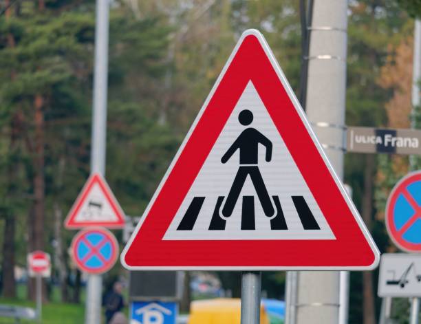 istock Red pedestrian crossing sign on a blurred background 1436923312