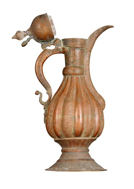 istock Antique copper jug with artistic chasing and engraving on a white background 1436923330