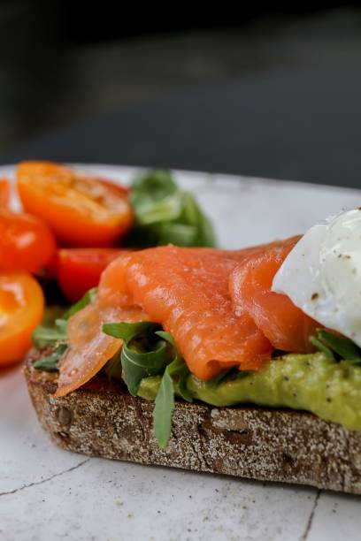istock Vertical view of a raw salmon bruschetta with cherry tomatoes on the side 1436924123