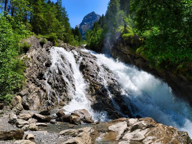 istock View of a river falling down a rocky slope in the forest under the blue sky 1436924189