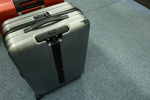 Photo of two suitcases at the airport containing clothes and other things while traveling