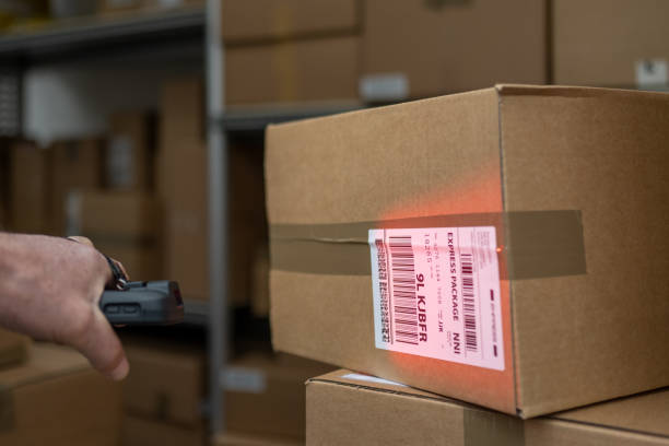 istock Delivery person scanning packages 1436929107
